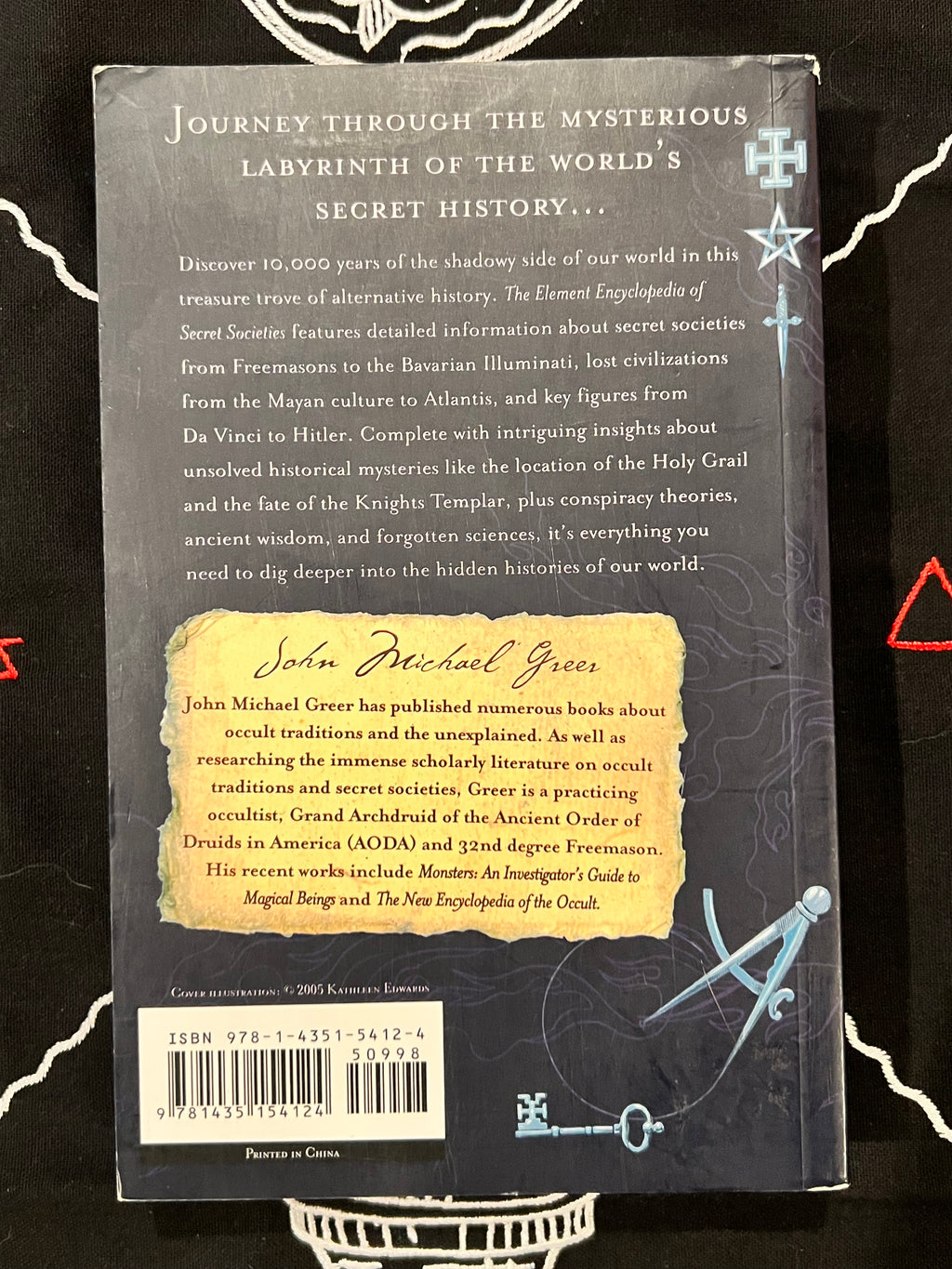 Back cover of the book 'The Element Encyclopedia' by John Michael Grease, featuring a dark gray background with white text, a yellow title label, and blue celestial illustrations.