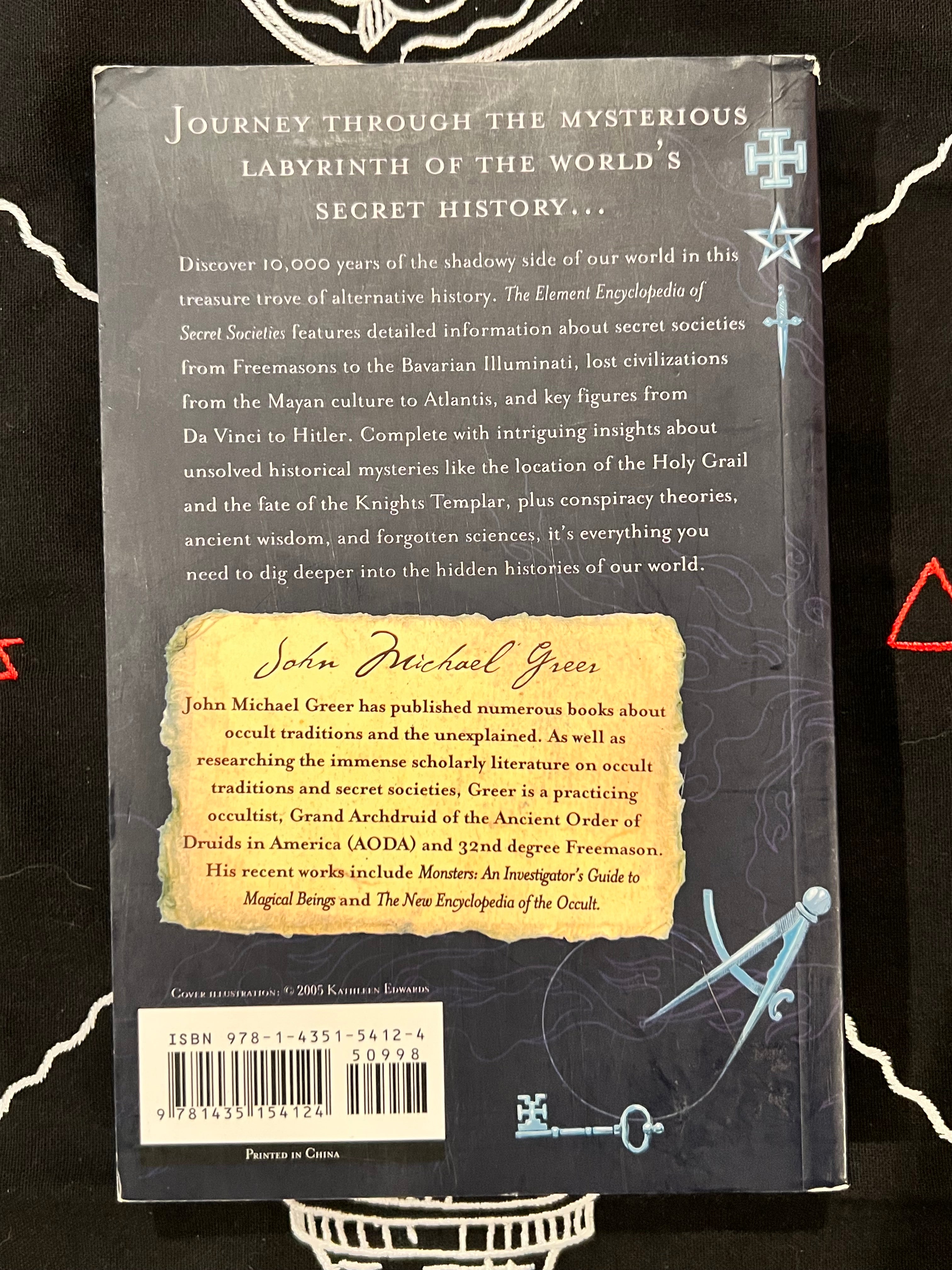 Back cover of the book 'The Element Encyclopedia' by John Michael Grease, featuring a dark gray background with white text, a yellow title label, and blue celestial illustrations.