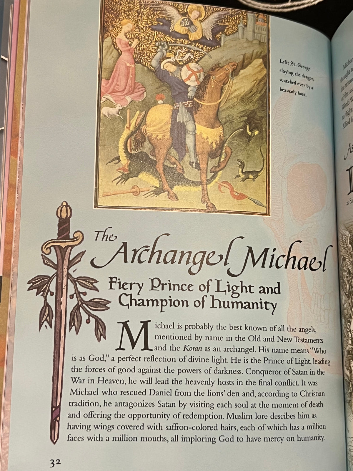 An open book page featuring an illustration of the Archangel Michael with a sword and a lion, accompanied by text titled 'The Archangel Michael' and a decorative ornamental letter M.