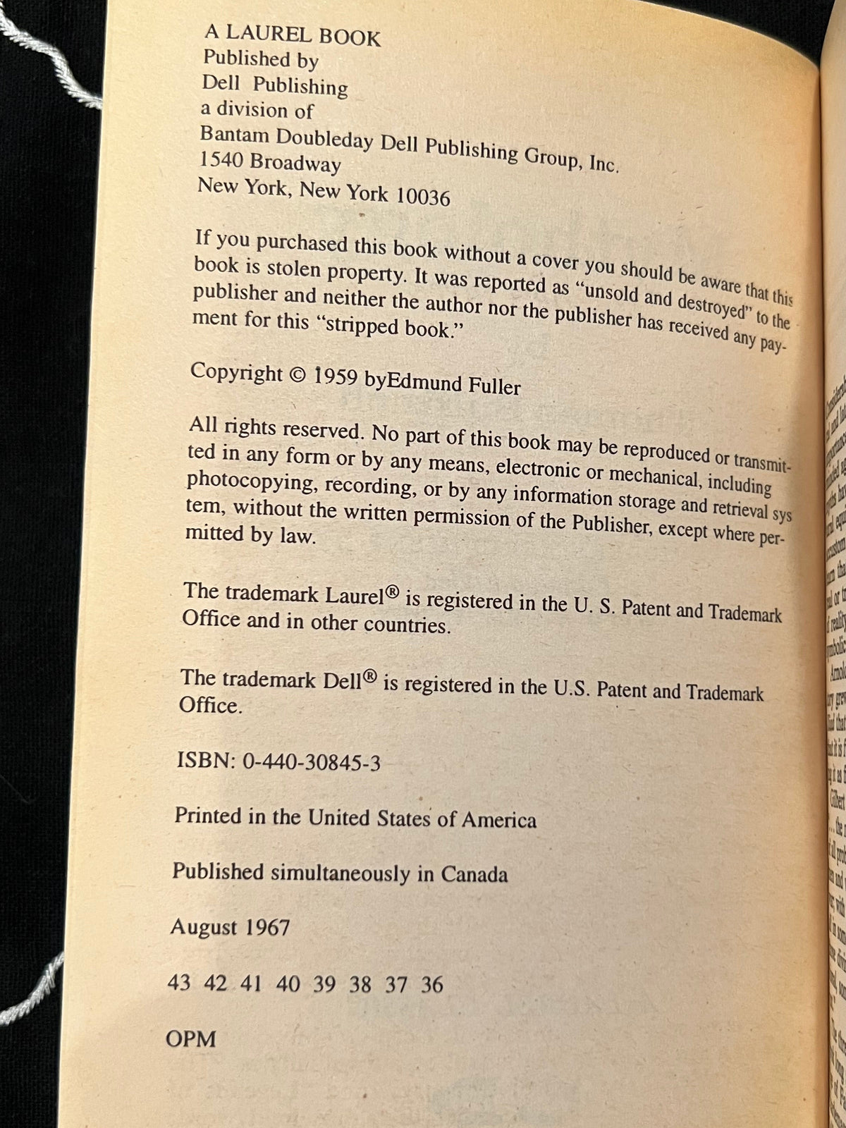 A close-up of a book's printed copyright page, showing the title 'A Laurel Book' and publisher details for Dell Publishing, photographed against an open book background.