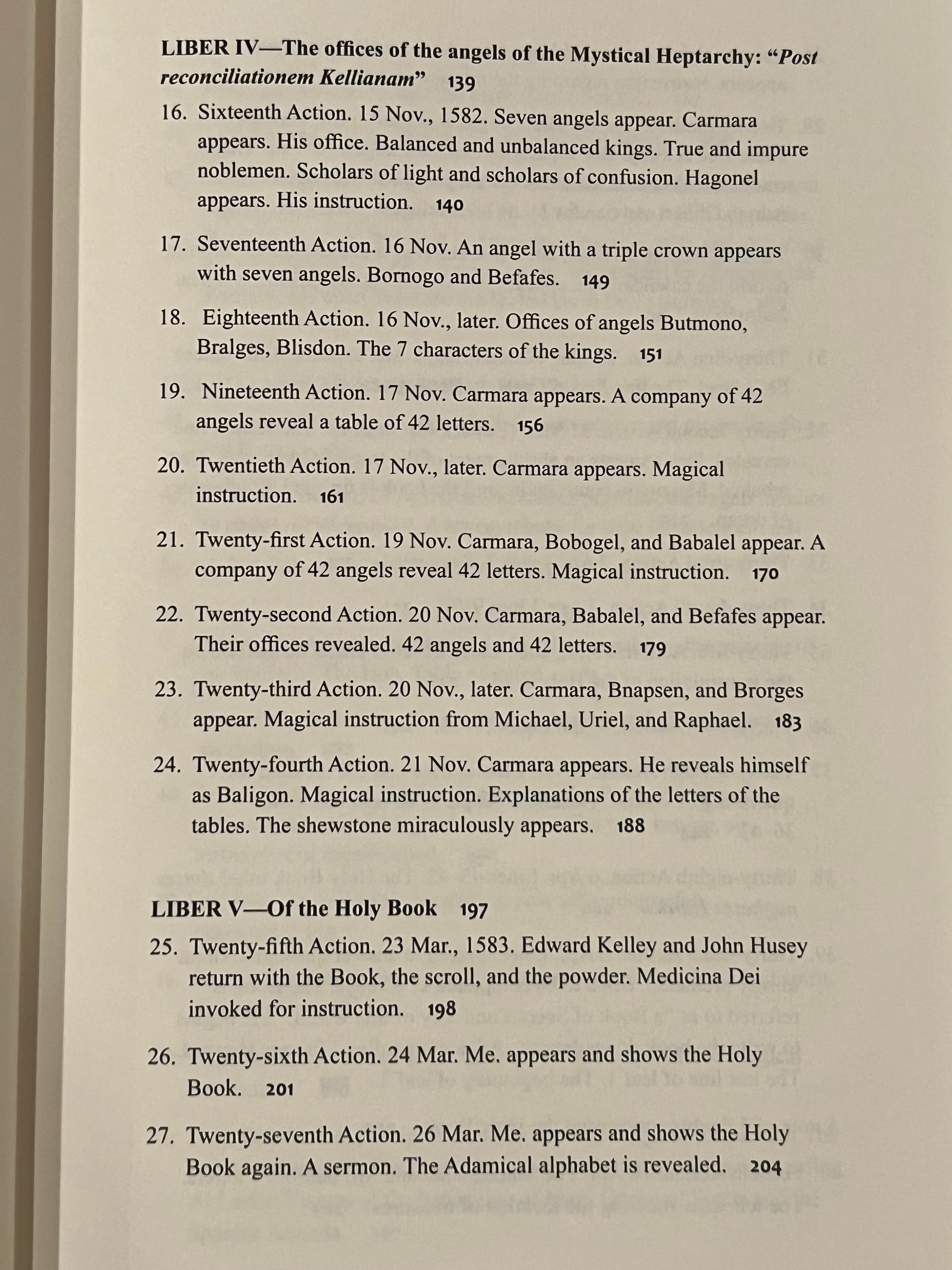 A close-up of an open book's inner pages showing printed text from what appears to be a religious or theological text, with headings 'LIBER IV' and 'LIBER V' and numbered verses.