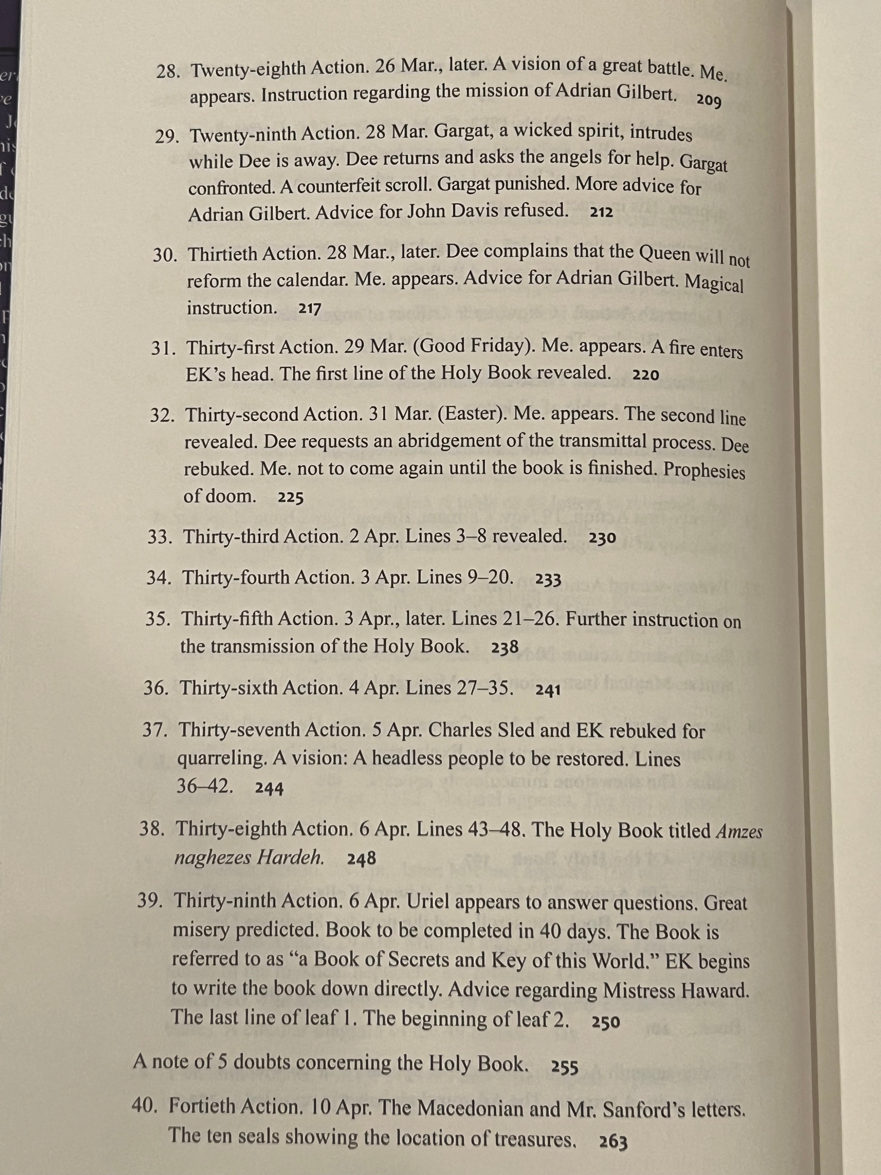 A close-up of an open book showing printed text pages, with the left page turned slightly to reveal both pages and the book's cream-colored paper.