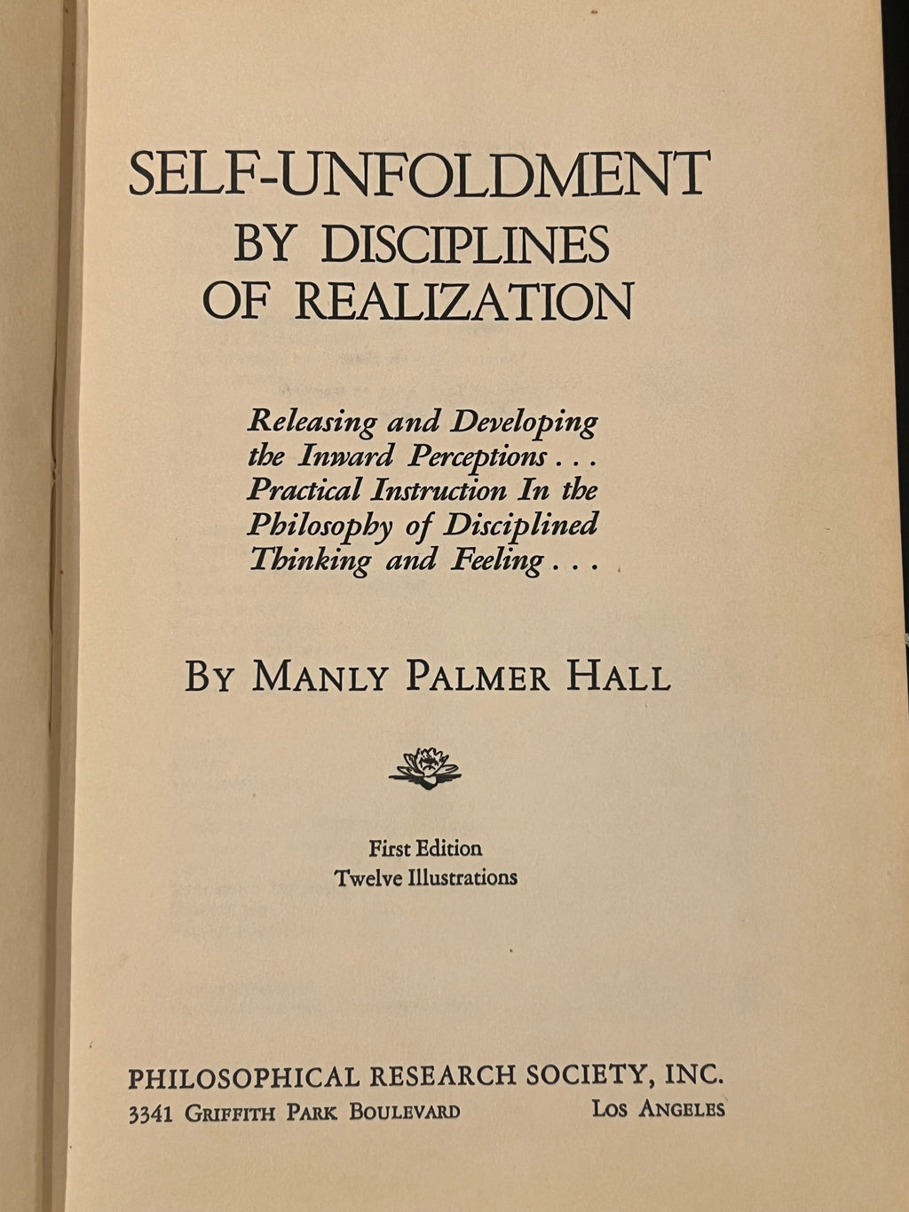 The front cover of the book 'Self-Unfoldment by Disciplines of Realization' by Manly Palmer Hall, published by Philosophical Research Society, Inc. The cover is a warm beige paper with black printed text and a small floral emblem.