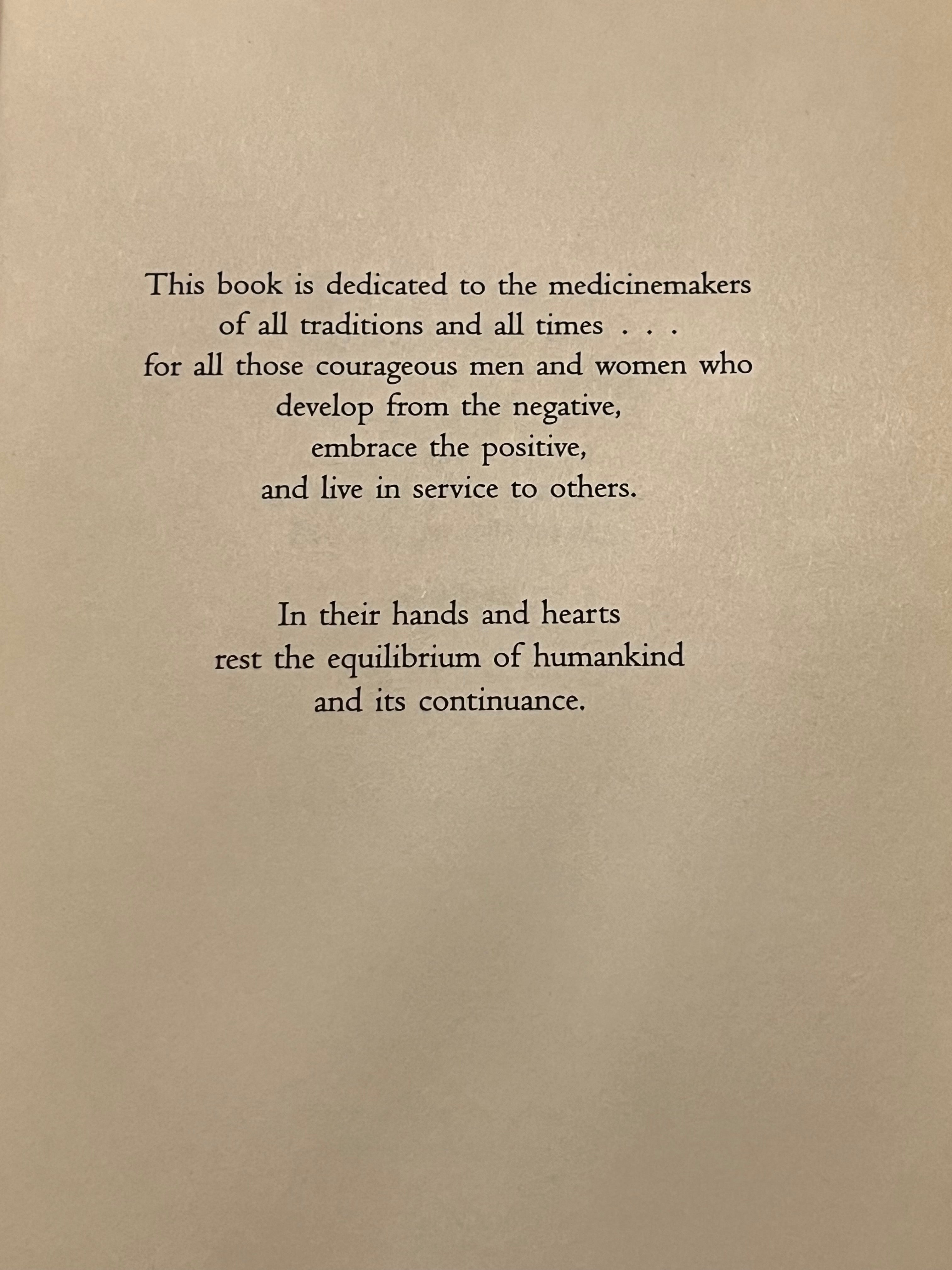 A book page with black serif text on a warm beige background, featuring a dedication paragraph and a second paragraph below it.