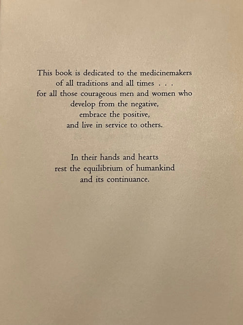 A book page with black serif text on a warm beige background, featuring a dedication paragraph and a second paragraph below it.