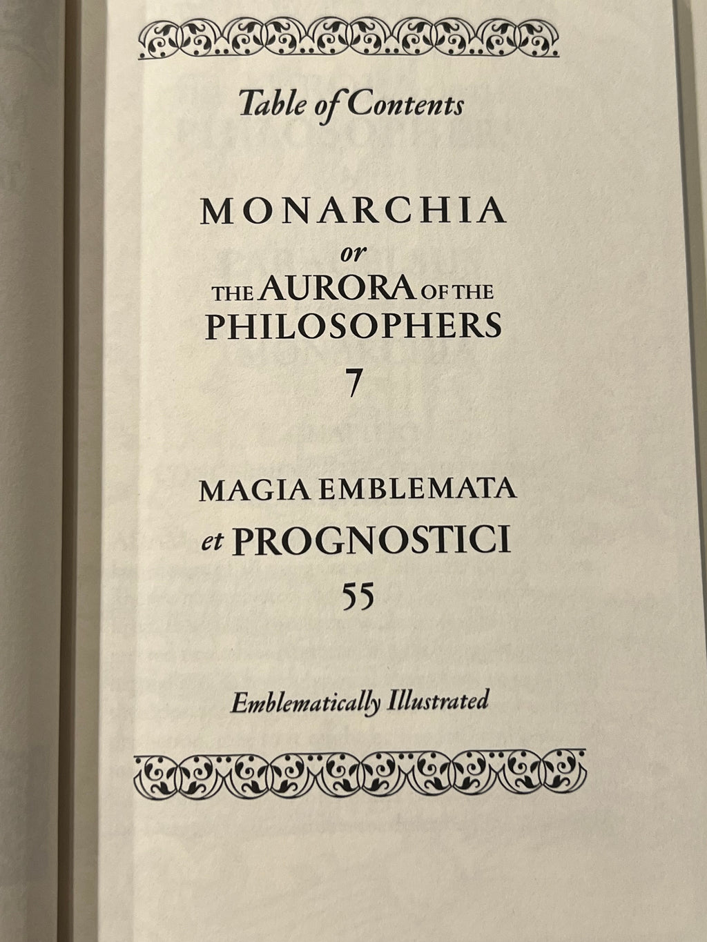 A close-up of a printed book page showing the table of contents for 'Monarchia or the Aurora of the Philosophers', with decorative ornamental borders at the top and bottom.