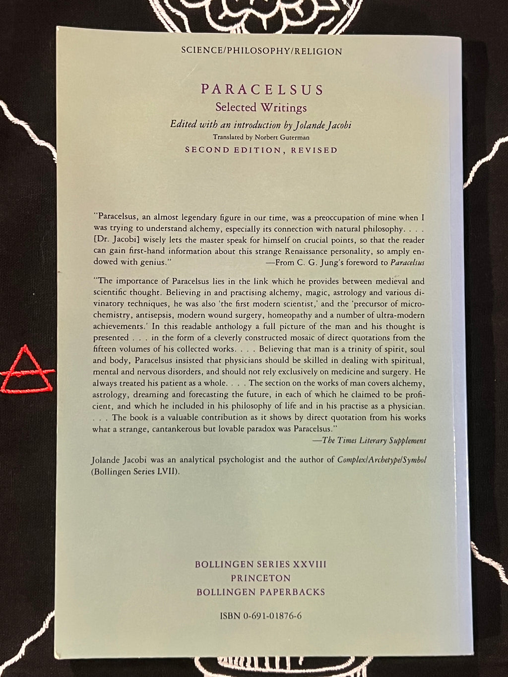 A book cover for 'Paracelsus Selected Writings' by Jolande Jaques, published by Bollingen Series XVIII, Princeton Bollingen Paperbacks. The cover is a muted sage green with black text, photographed flat on a dark, textured background.