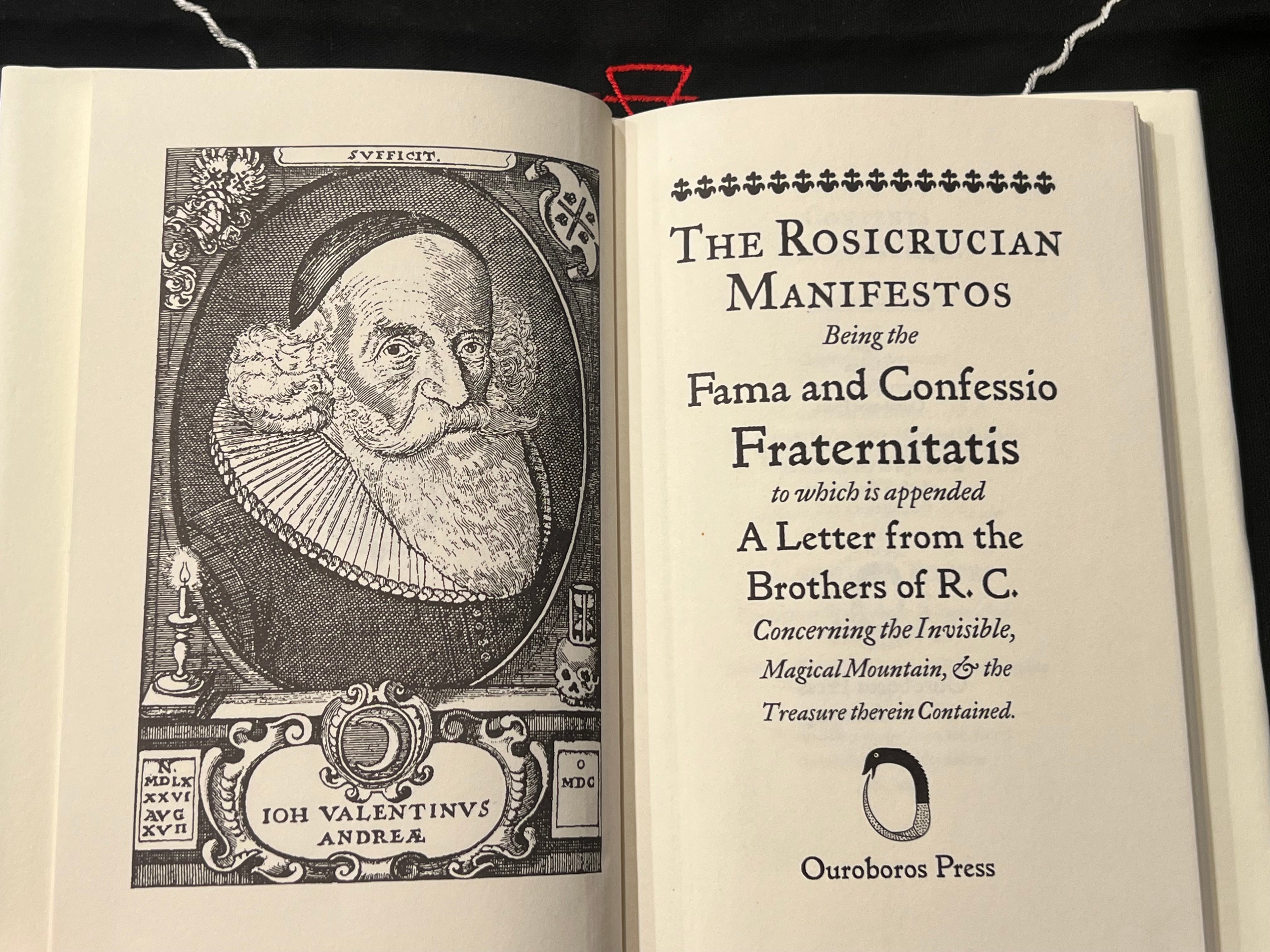 An open vintage book showing the title page of 'The Rosicrucian Manifestos' with a black-and-white portrait engraving on the left page and printed text on the right page. The publisher mark 'Ouroboros Press' is visible at the bottom.