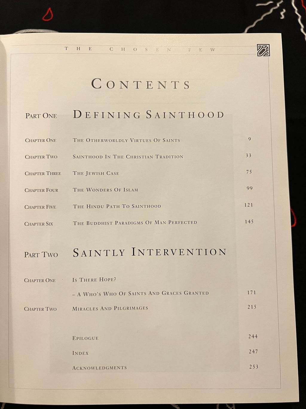 An open book showing the table of contents page from 'The Chosen Few', featuring black text on an off-white page against a dark background.