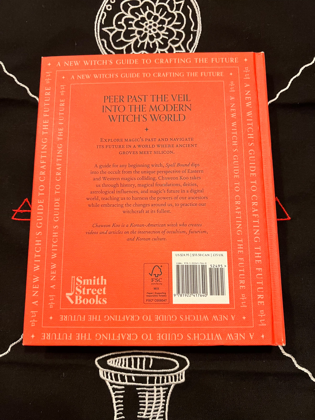The back cover of the book 'A New Witch's Guide to Crafting the Future' by Smith Street Books, featuring a bright orange-red background with black text and a barcode.