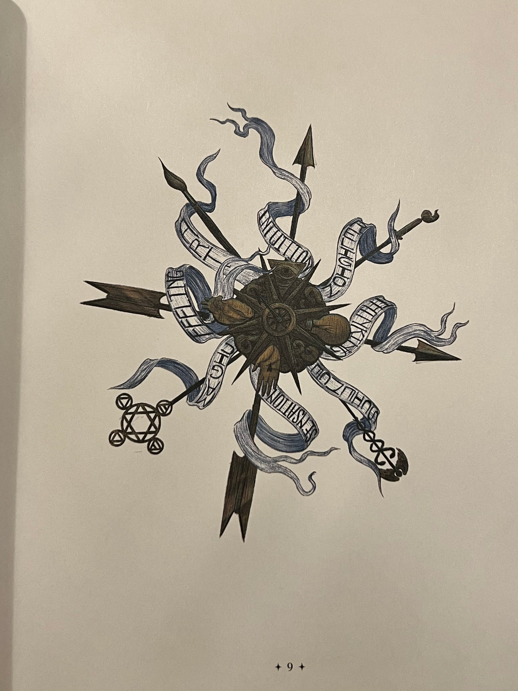 A black ink illustration of a compass rose design with banners and arrows, printed on a cream-colored page.
