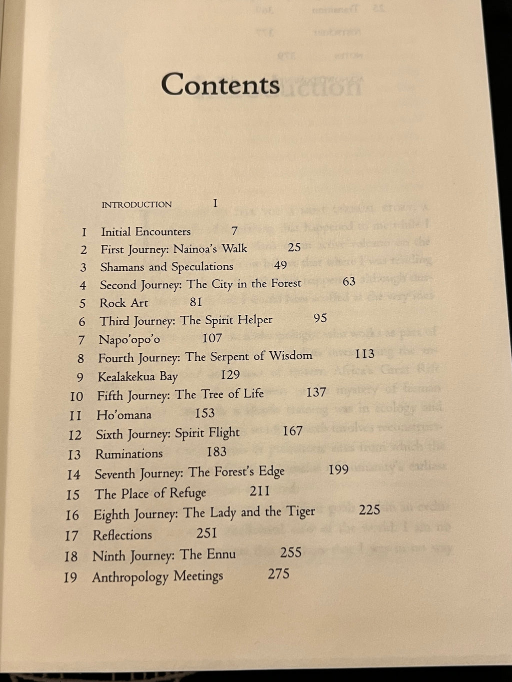 A printed book or booklet contents page with black text on an off-white page, photographed against a dark background.