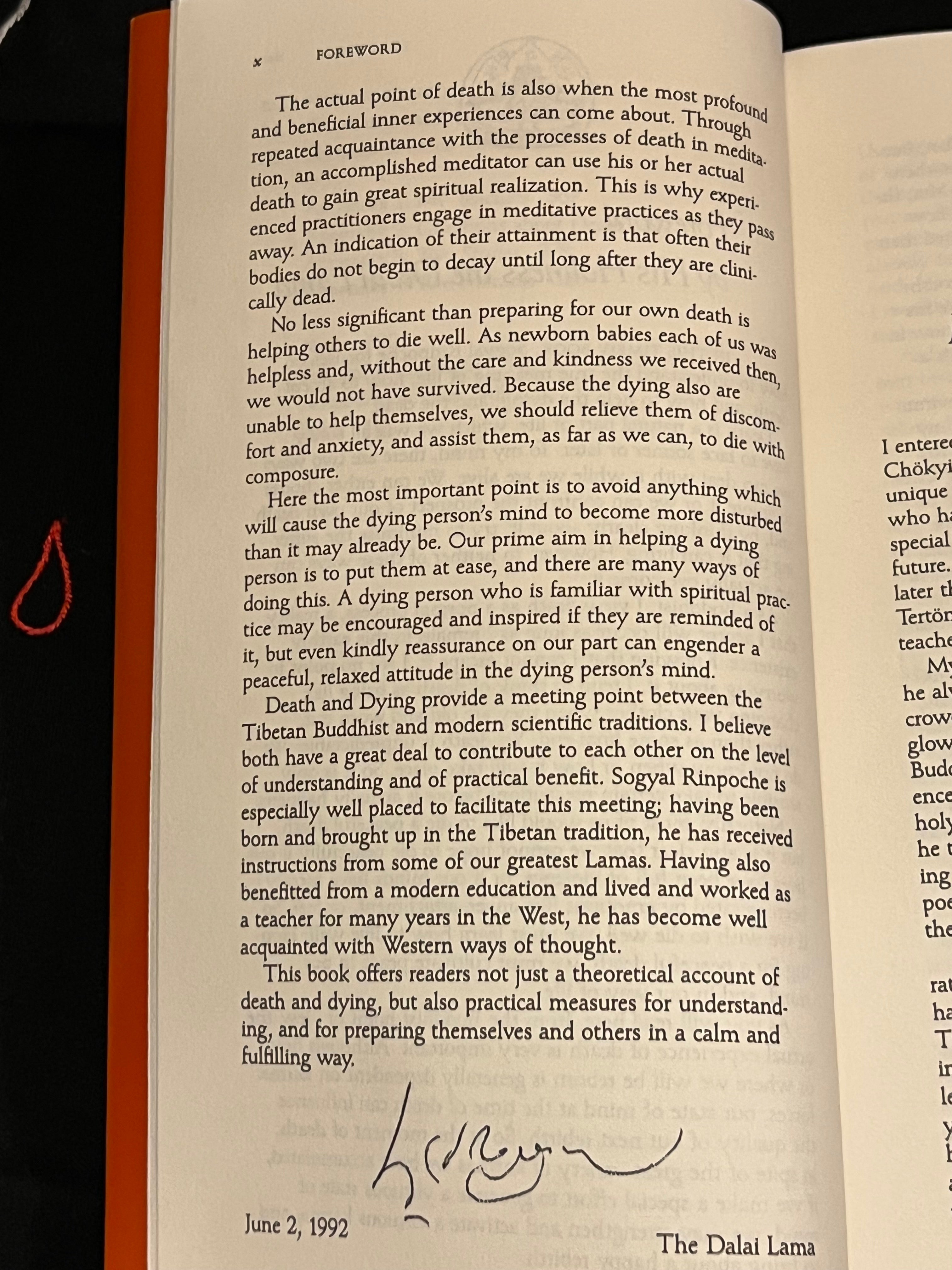 A scanned or photographed open book page showing printed text, a handwritten mark, and the title 'The Dalai Lama' at the bottom.