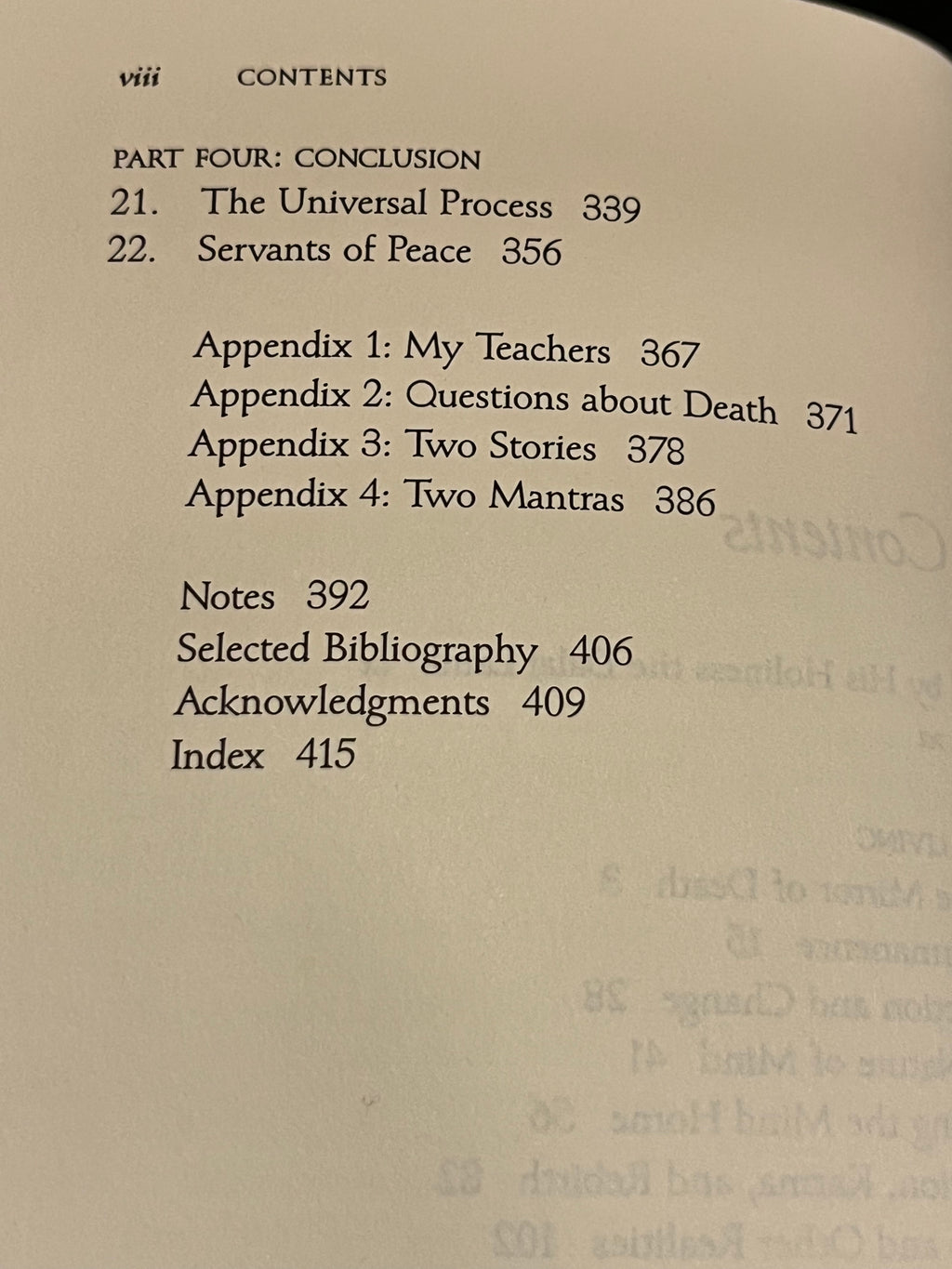 A close-up of a printed book or booklet table of contents page with black text on an off-white page, including section headings, appendix titles, page numbers, and notes.