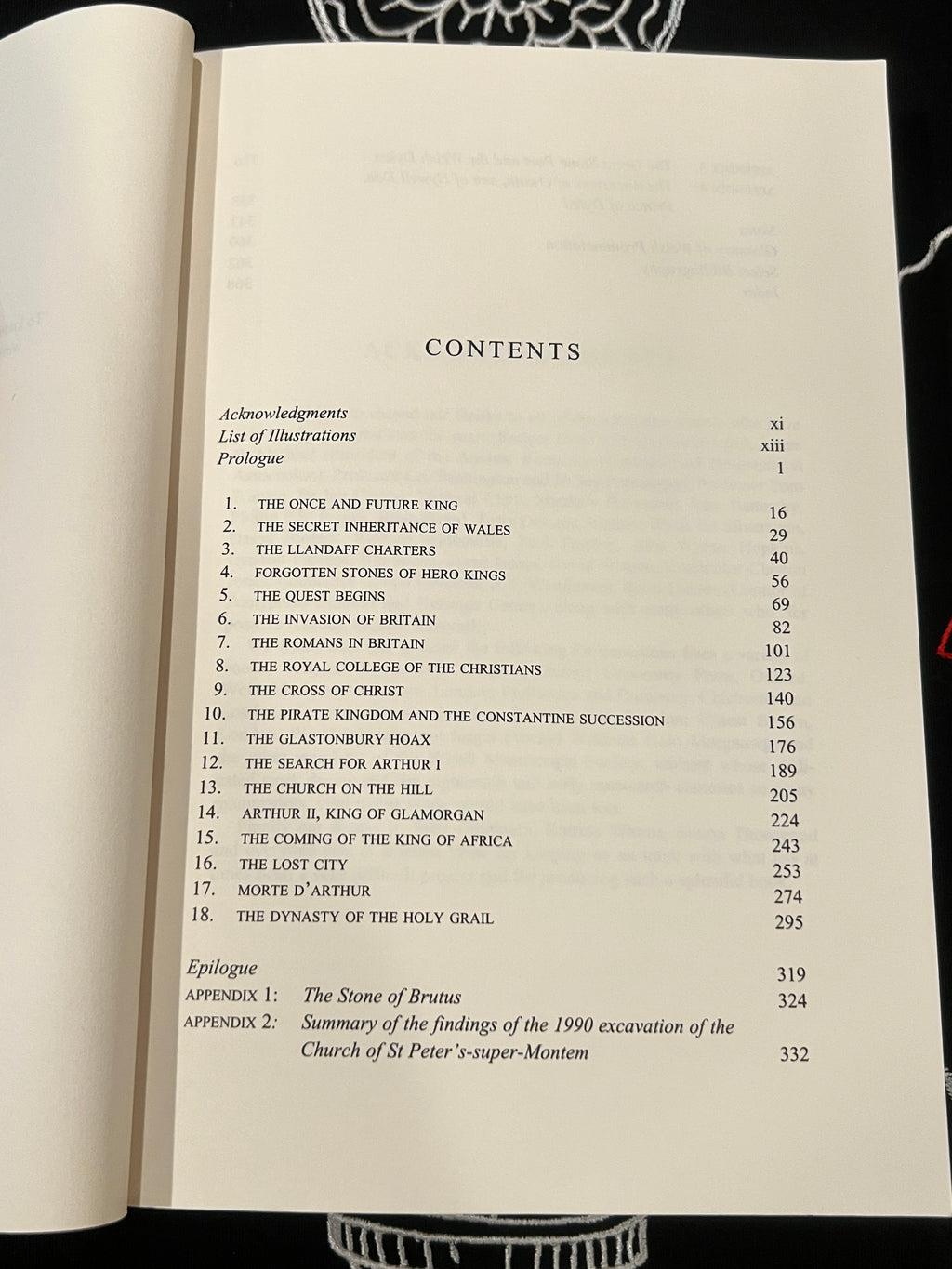 An open book showing the table of contents page, with printed text listing chapters, appendices, and page numbers on an off-white page.