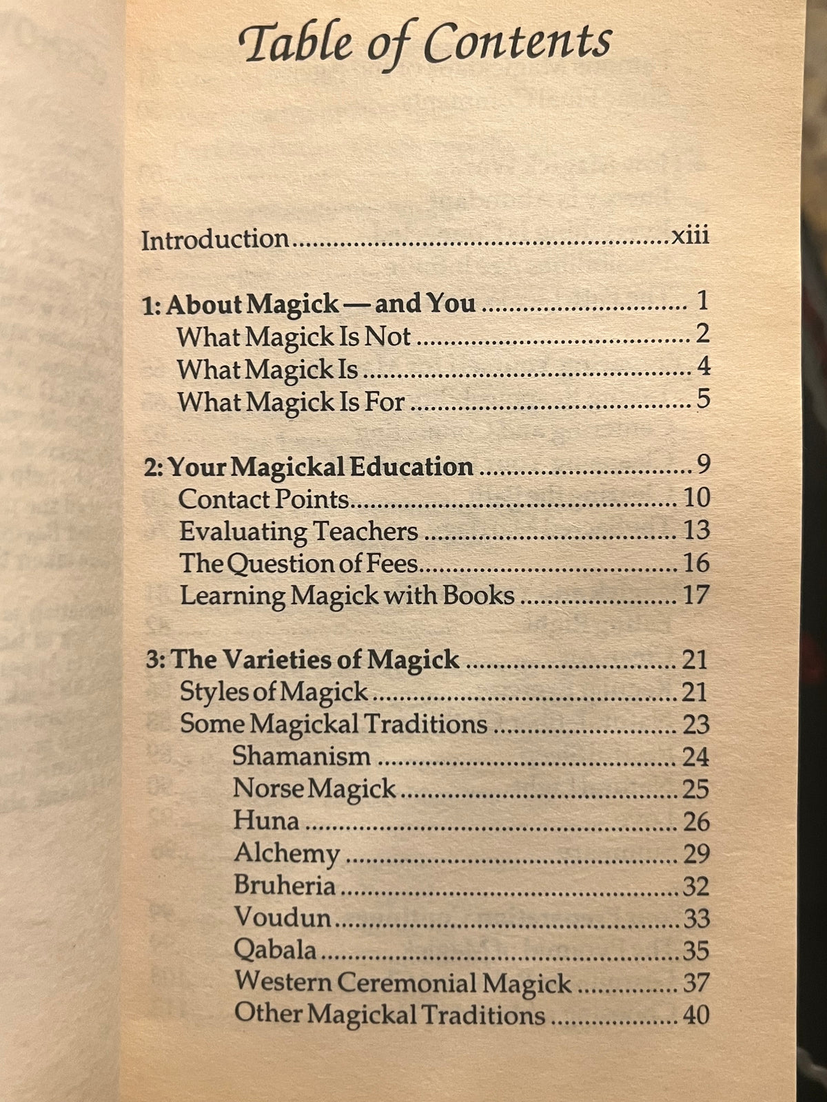 A printed table of contents page from a book or booklet, showing chapter titles and page numbers on aged beige paper against a dark background.
